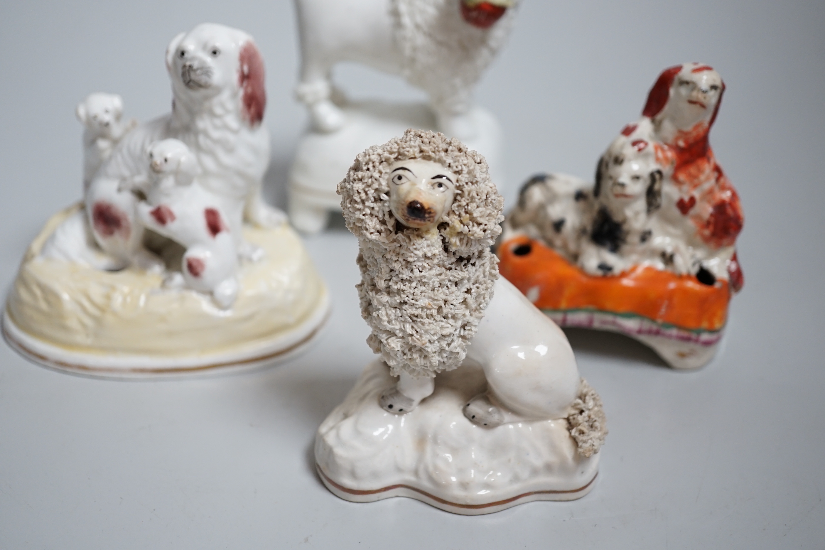 Five Victorian Staffordshire dog groups, the largest 12cm high